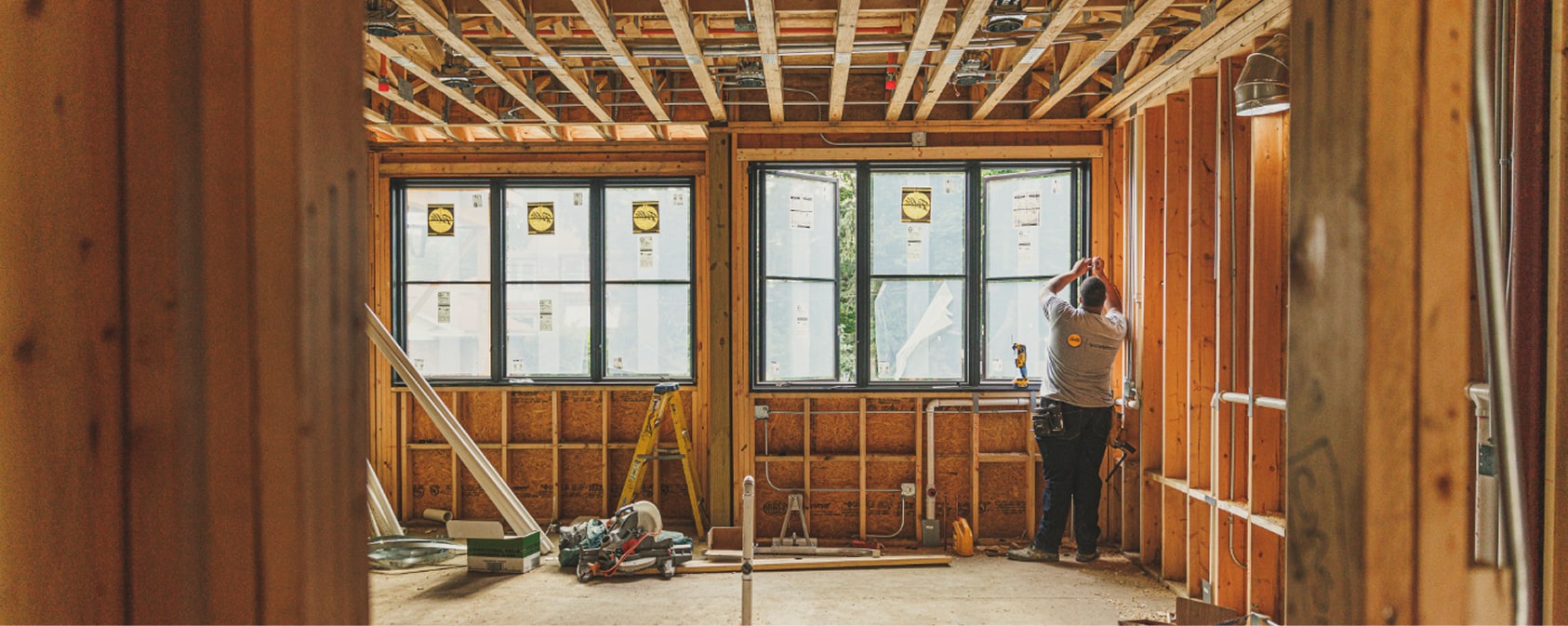 Pella Contractor installing Pella windows in unfinished home with exposed studs.